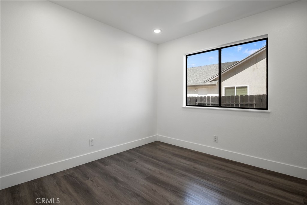 4225 Saddleback Road Palmdale, CA 93552 - Photo 37 of 61 wooden floor in an empty room with a window