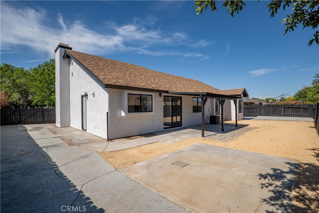 4225 Saddleback Road Palmdale, CA 93552 - Photo 43 of 61 a front view of house with yard and trees in the background