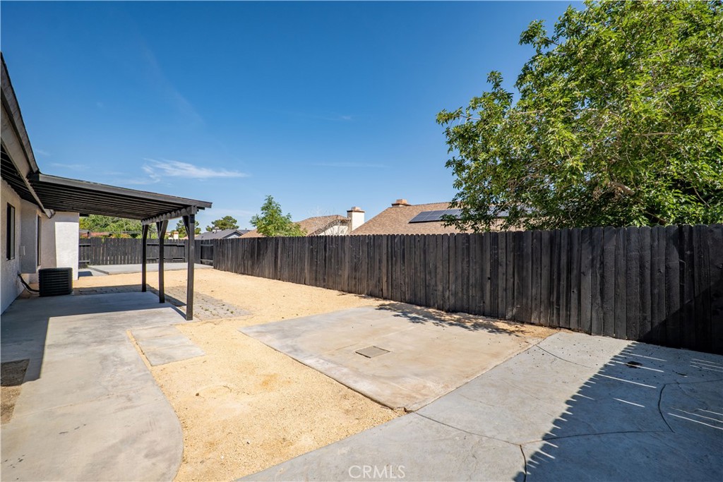 4225 Saddleback Road Palmdale, CA 93552 - Photo 47 of 61 a patio with table and chairs and wooden fence