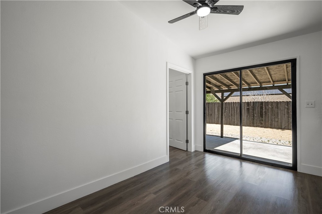 4225 Saddleback Road Palmdale, CA 93552 - Photo 48 of 61 a view of an empty room with wooden floor and a window