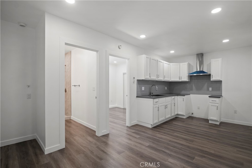 4225 Saddleback Road Palmdale, CA 93552 - Photo 51 of 61 a large kitchen with a wooden floor and white stainless steel appliances