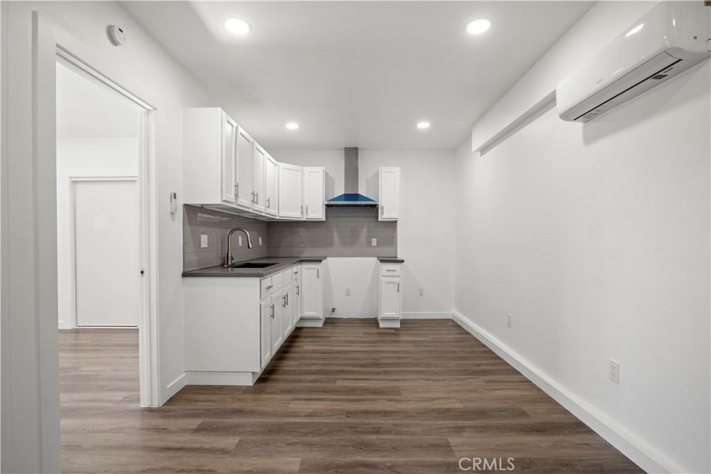 4225 Saddleback Road Palmdale, CA 93552 - Photo 52 of 61 a kitchen with granite countertop white cabinets and stainless steel appliances