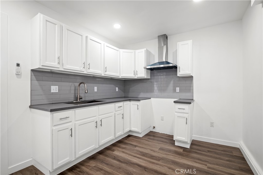 4225 Saddleback Road Palmdale, CA 93552 - Photo 53 of 61 a kitchen with granite countertop white cabinets and a stove