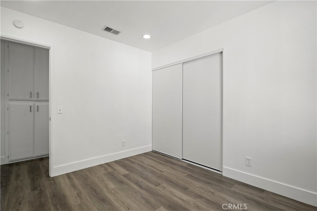 4225 Saddleback Road Palmdale, CA 93552 - Photo 57 of 61 a view of an empty room with wooden floor