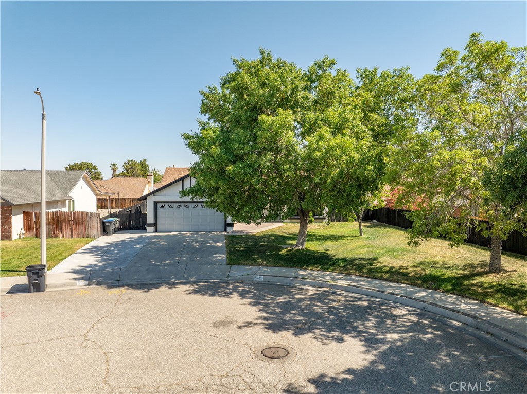 4225 Saddleback Road Palmdale, CA 93552 - Photo 6 of 61 a front view of a house with a yard and garage