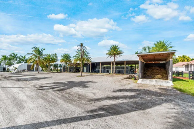 a front view of a house with a yard and seating space