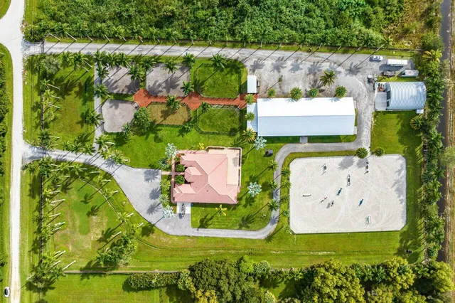 an aerial view of a house with a yard and garden