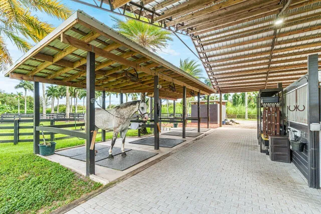 a view of a porch with furniture and a yard