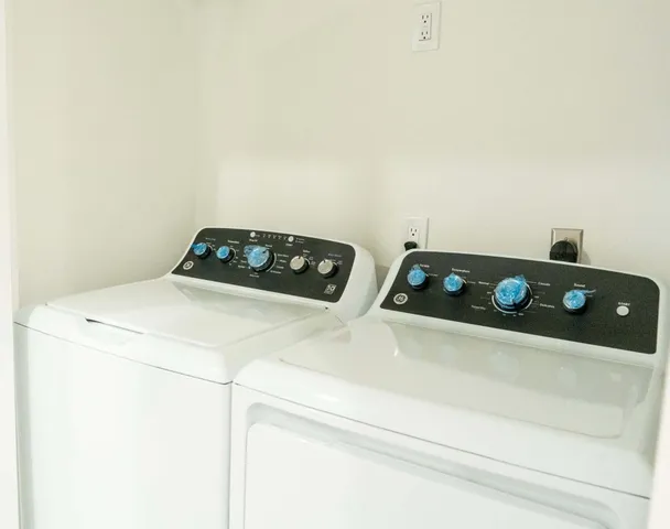 a close up of a utility room with washer and dryer