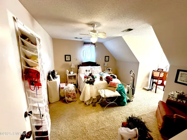 a bedroom with furniture and a chandelier