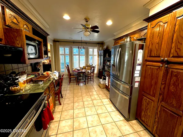 a kitchen with granite countertop lots of counter top space and stainless steel appliances