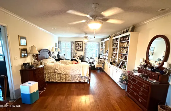 a bedroom with furniture and wooden floor