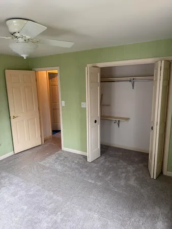 a view of a hallway with wooden floor and entryway