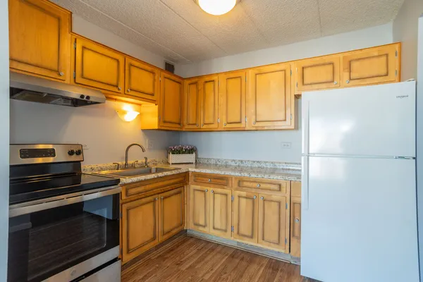 a kitchen with stainless steel appliances granite countertop a sink stove and cabinets