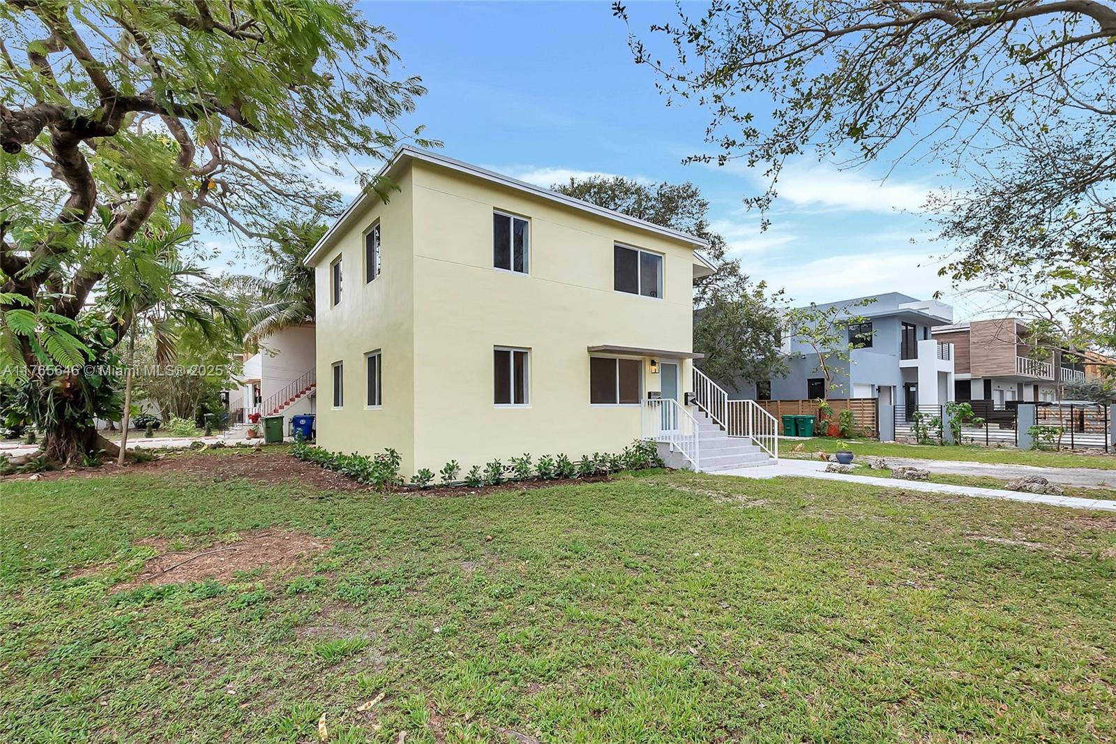 3402 Day Avenue Miami, FL 33133 - Photo 16 of 21 a view of a white house with a big yard and large trees