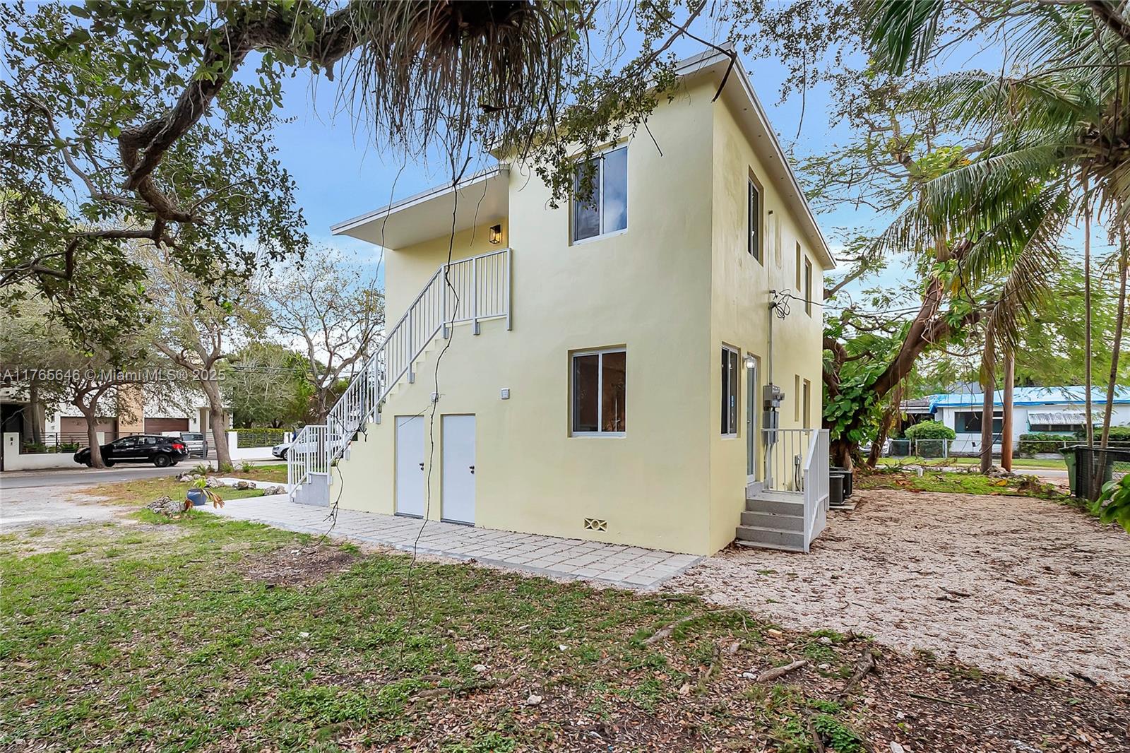 3402 Day Avenue Miami, FL 33133 - Photo 18 of 21 a view of a white house with a yard and sitting area