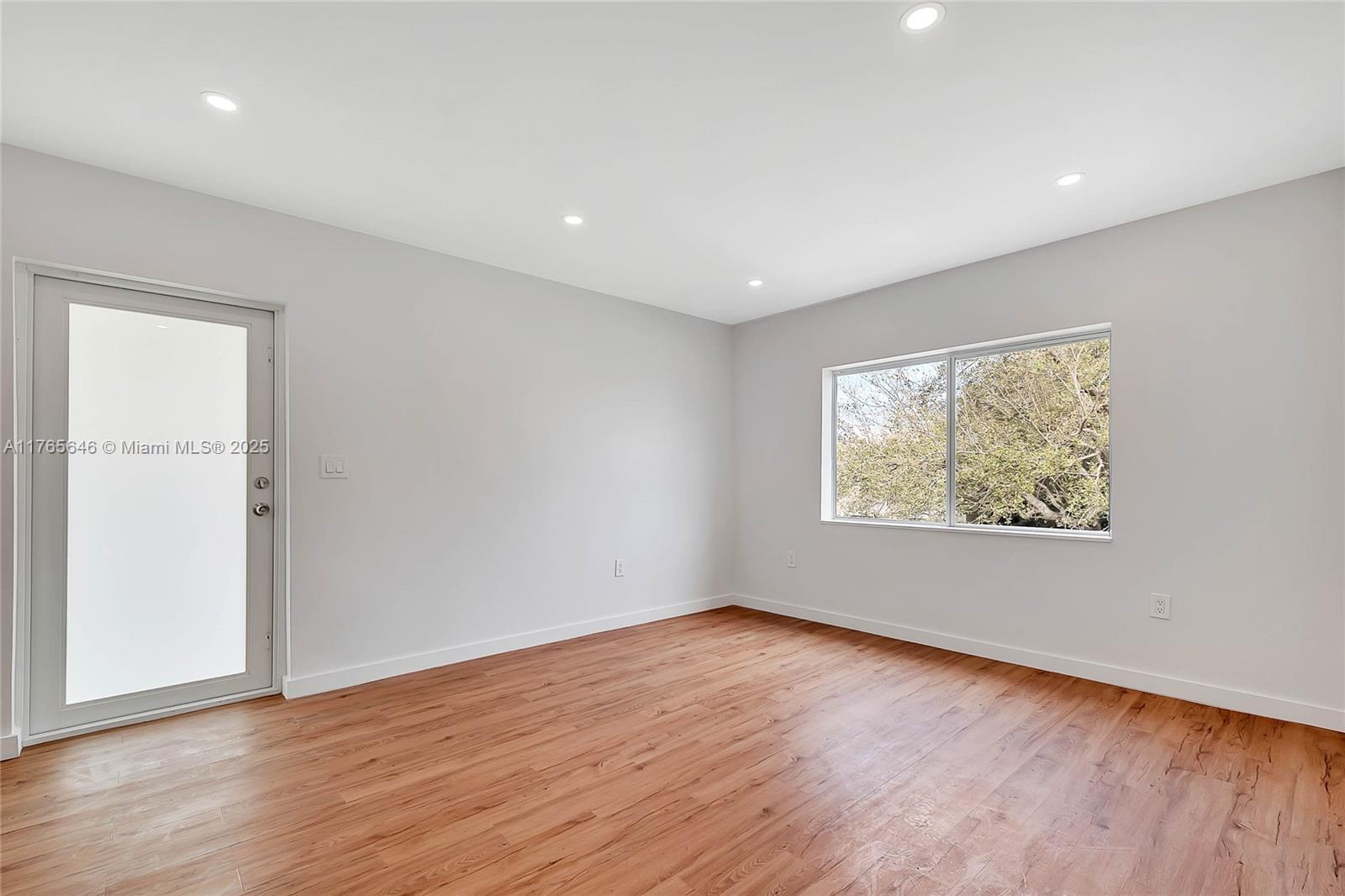 3402 Day Avenue Miami, FL 33133 - Photo 2 of 21 an empty room with wooden floor and windows