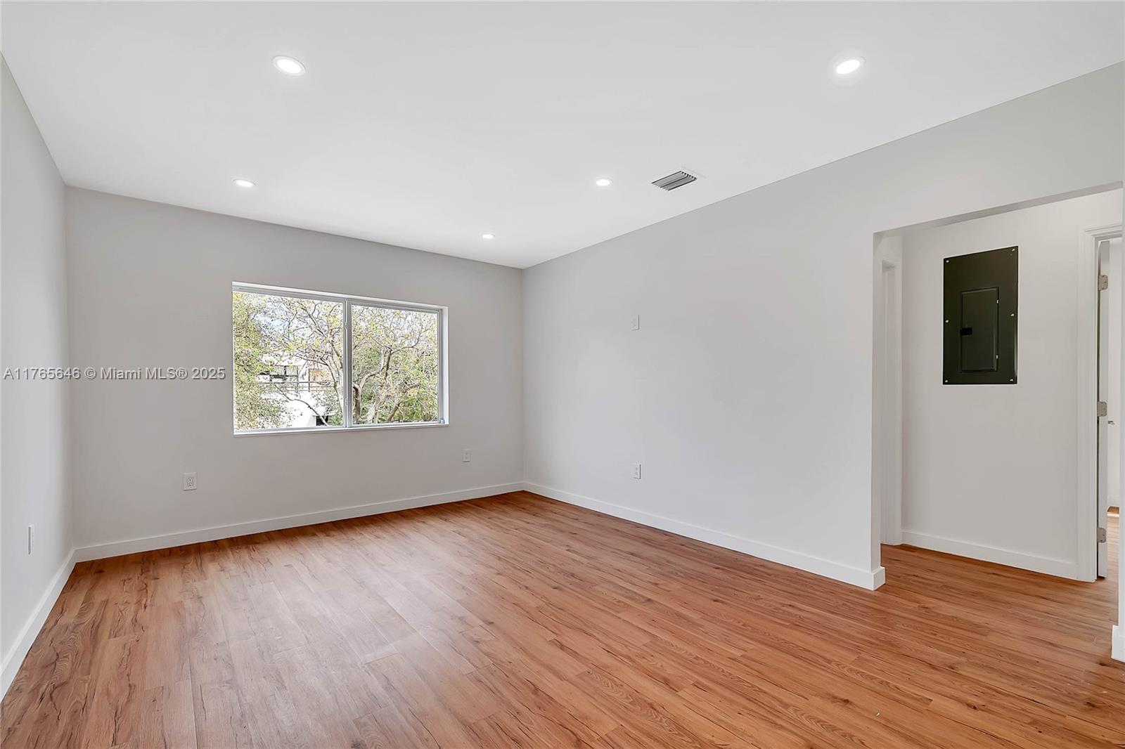 3402 Day Avenue Miami, FL 33133 - Photo 3 of 21 a view of an empty room with wooden floor and a window