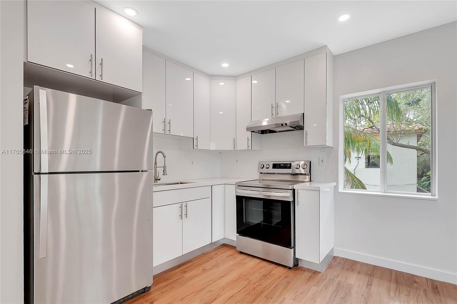 3402 Day Avenue Miami, FL 33133 - Photo 4 of 21 a kitchen with a refrigerator sink and cabinets