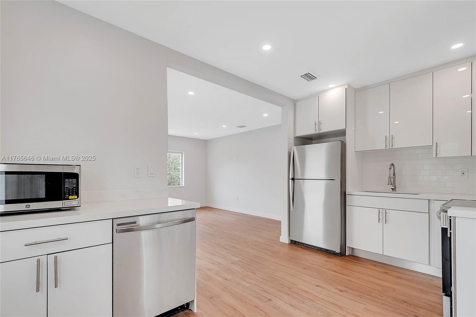 3402 Day Avenue Miami, FL 33133 - Photo 5 of 21 a kitchen with a refrigerator and a stove top oven