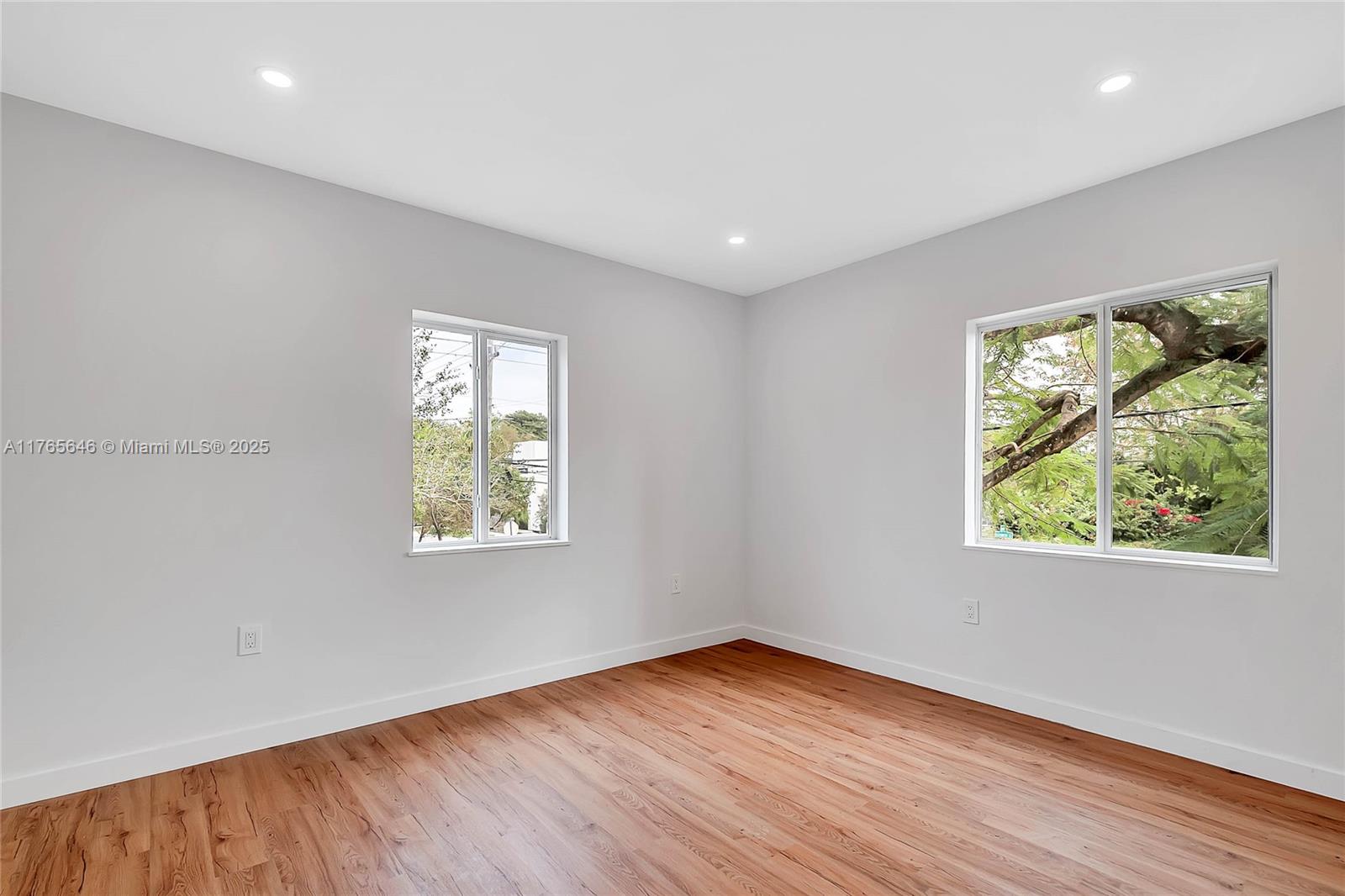 3402 Day Avenue Miami, FL 33133 - Photo 6 of 21 an empty room with wooden floor and windows