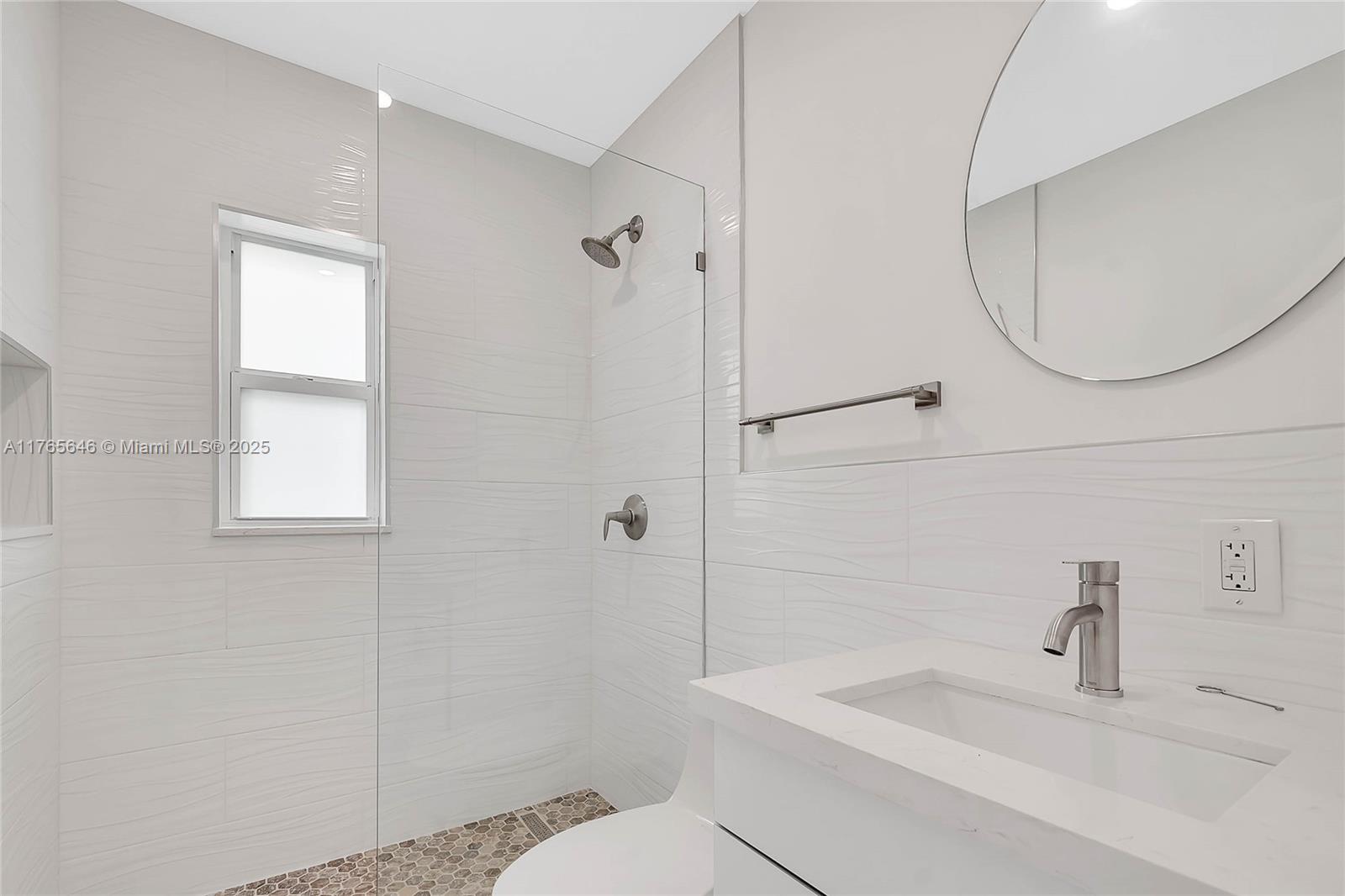 3402 Day Avenue Miami, FL 33133 - Photo 8 of 21 a bathroom with a sink a toilet and a mirror