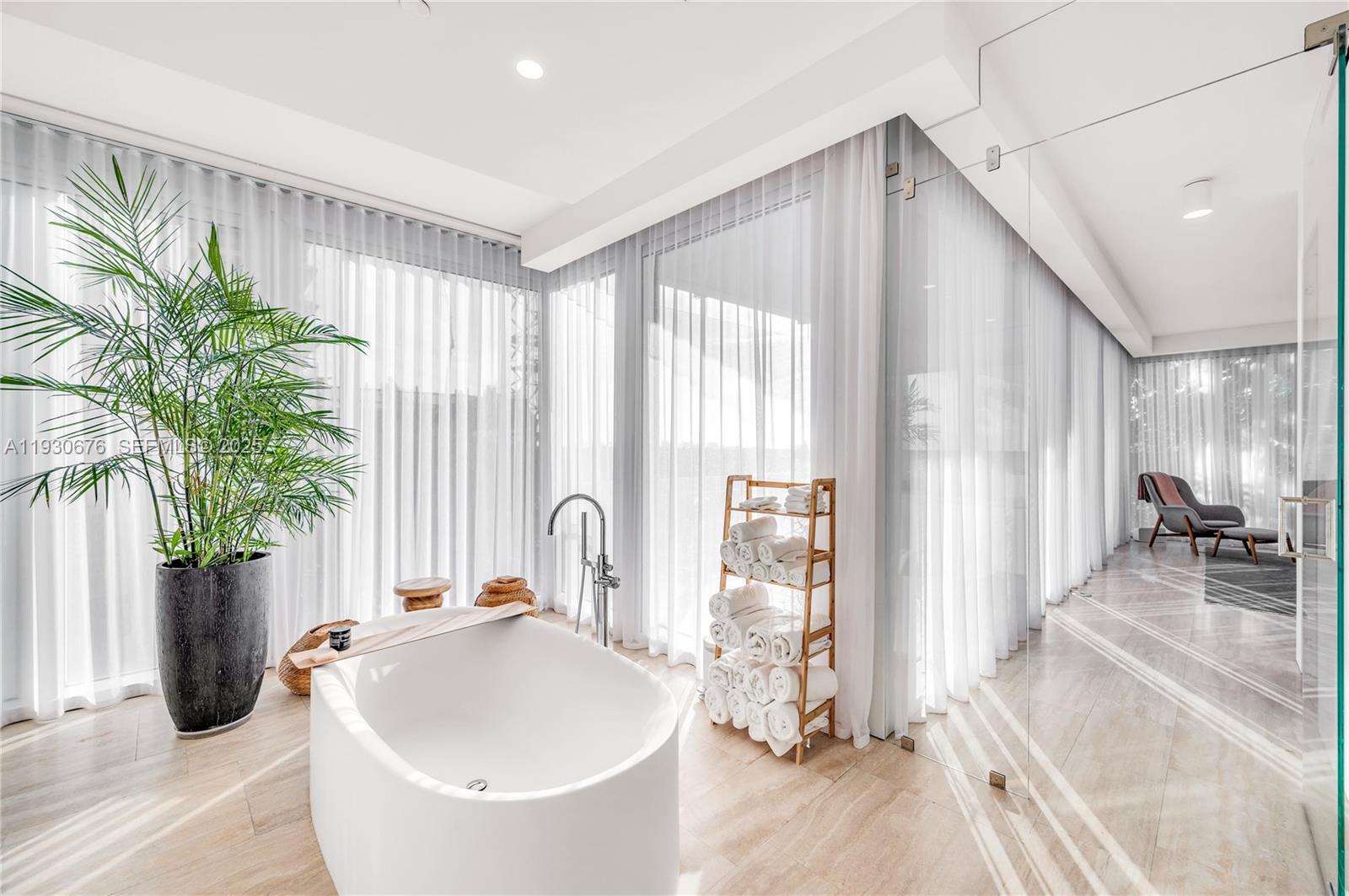 9001 Collins Avenue, Unit S402 Surfside, FL 33154 - Photo 13 of 19 a living room with a couch and a potted plant