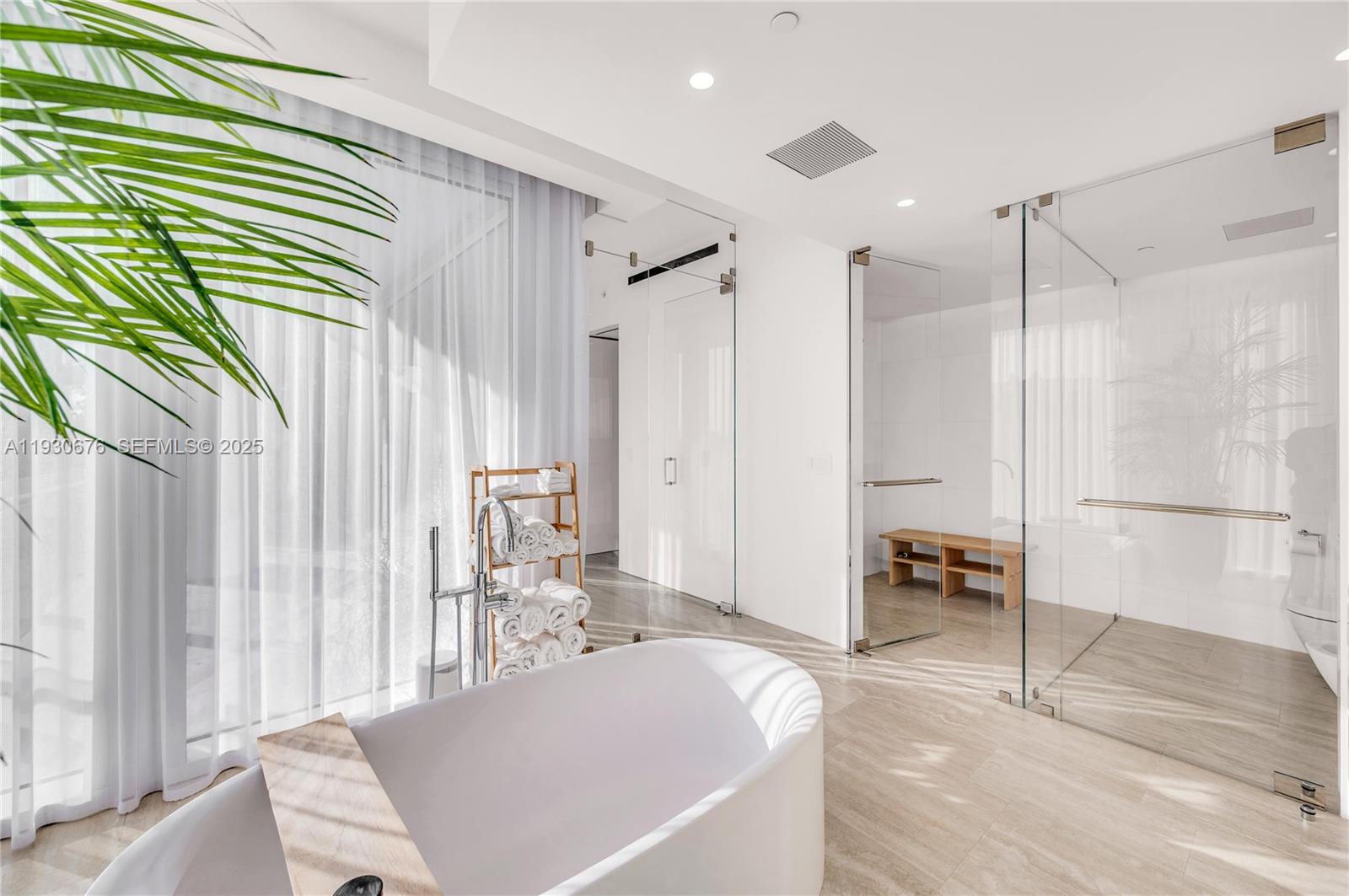 9001 Collins Avenue, Unit S402 Surfside, FL 33154 - Photo 14 of 19 a living room with a table chairs and a refrigerator