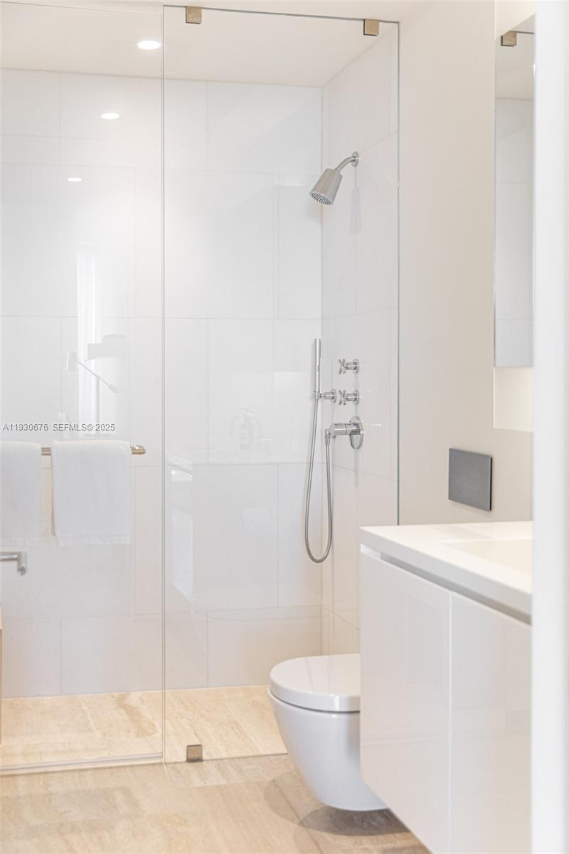 9001 Collins Avenue, Unit S402 Surfside, FL 33154 - Photo 19 of 19 a bathroom with a shower a toilet and a shower