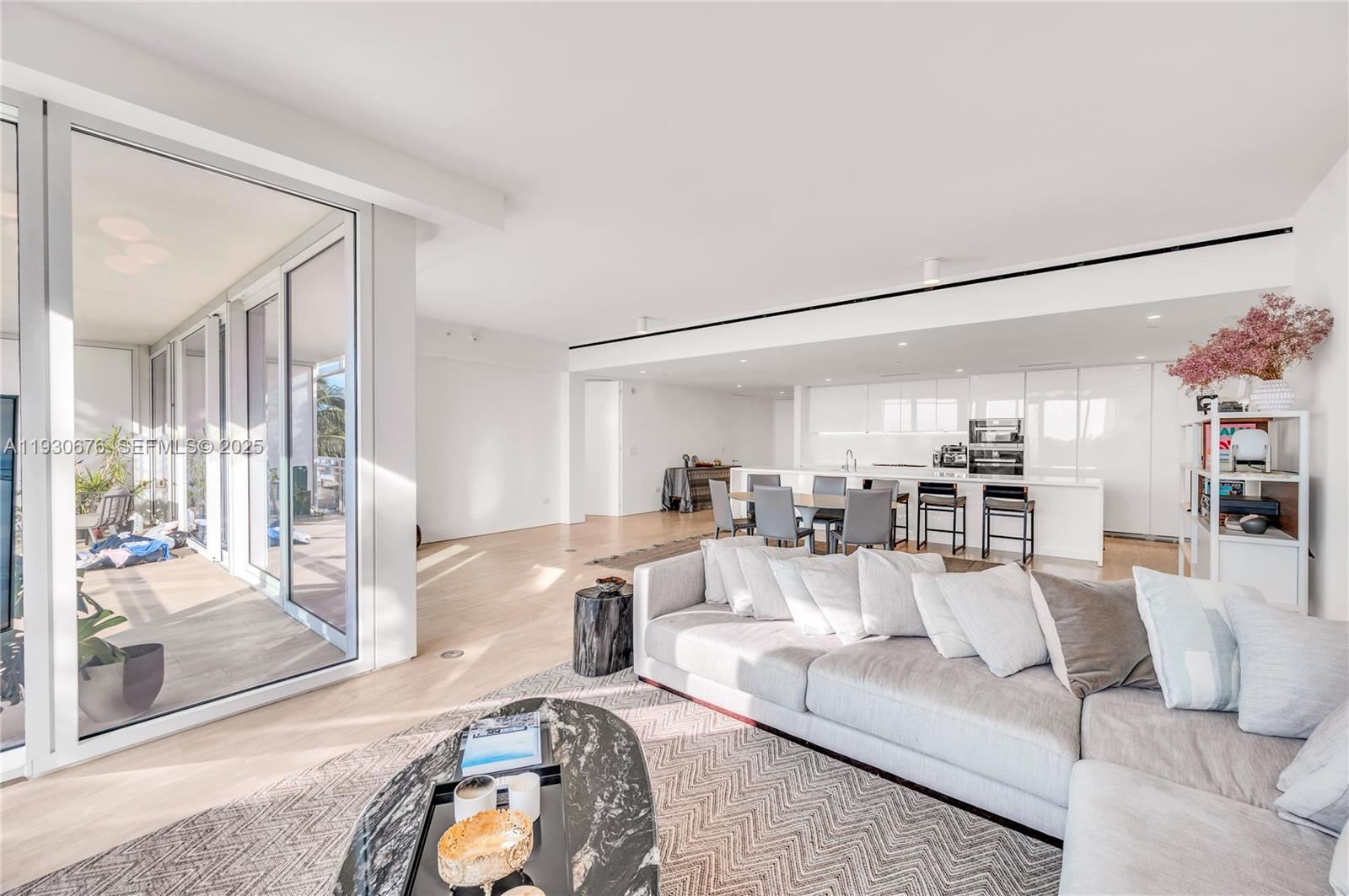 9001 Collins Avenue, Unit S402 Surfside, FL 33154 - Photo 2 of 19 a living room with furniture and a large window