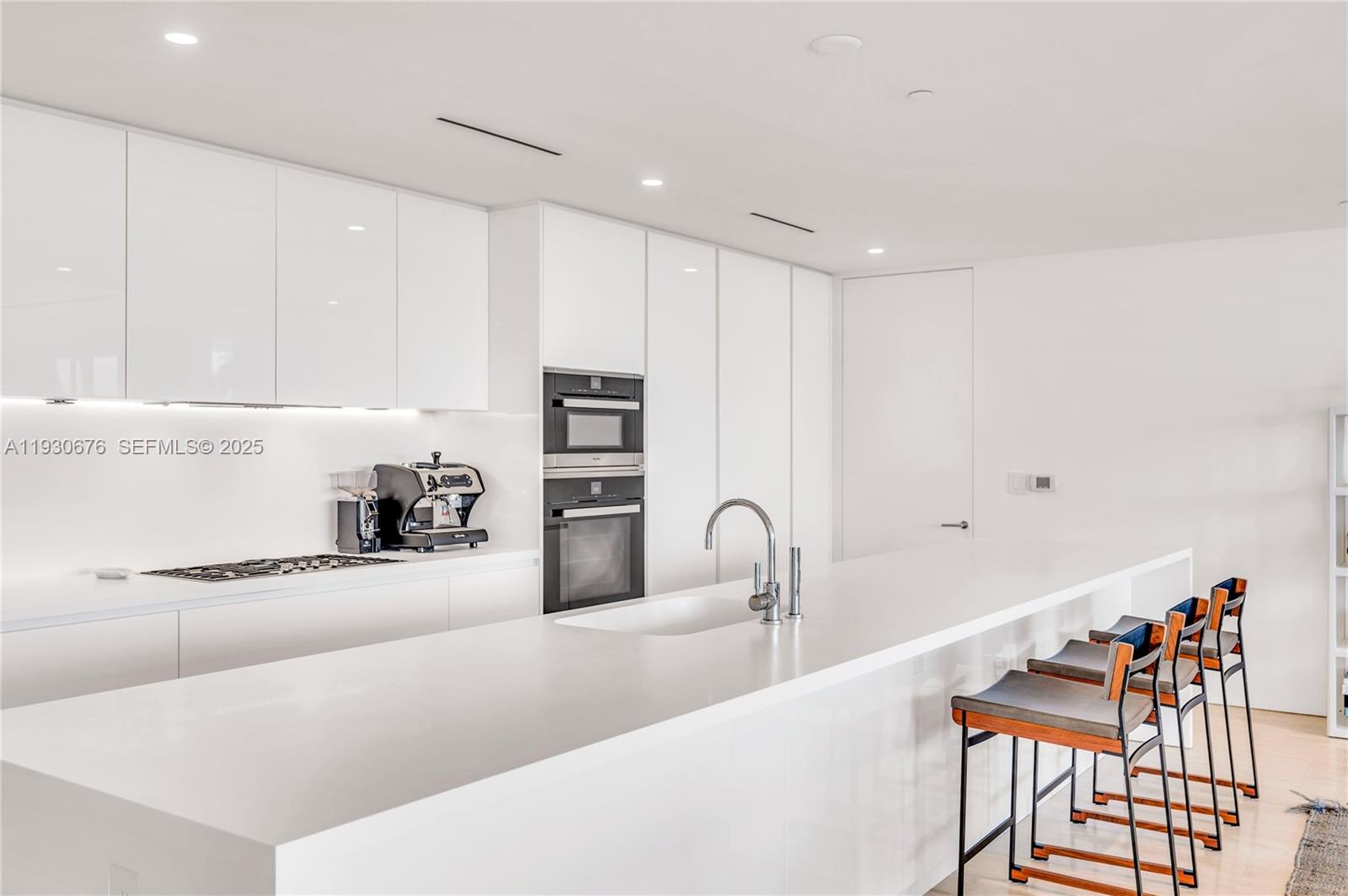 9001 Collins Avenue, Unit S402 Surfside, FL 33154 - Photo 5 of 19 a kitchen with stainless steel appliances kitchen island sink refrigerator and stove