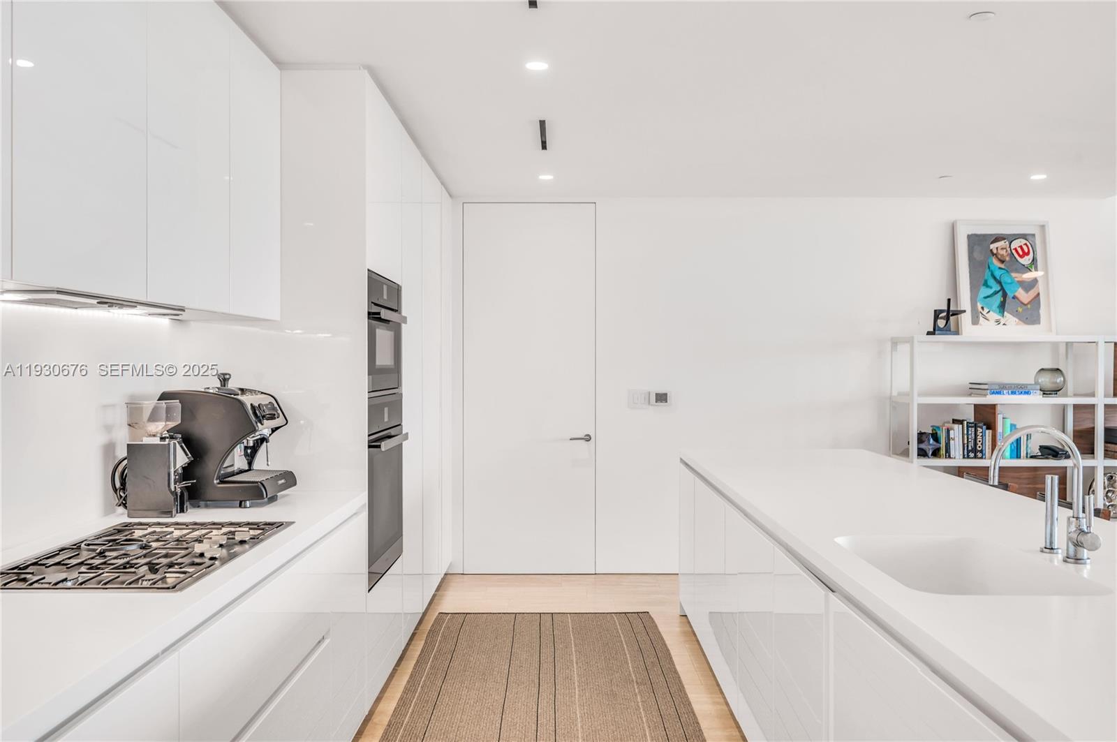 9001 Collins Avenue, Unit S402 Surfside, FL 33154 - Photo 6 of 19 a kitchen with a sink and wooden floor