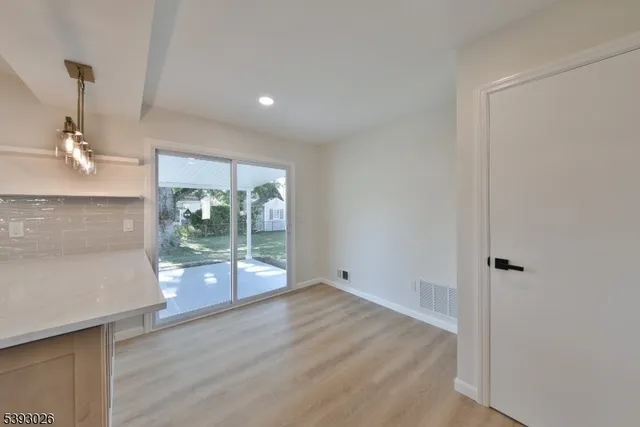 a view of a room with wooden floor and garden