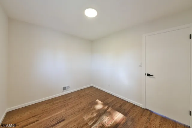 a view of a room with wooden floor
