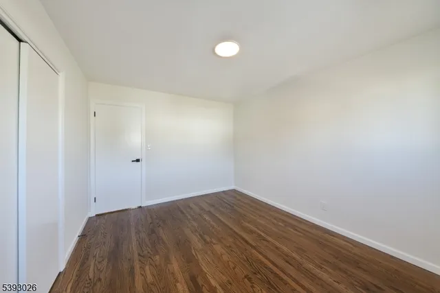 a view of room with wooden floor