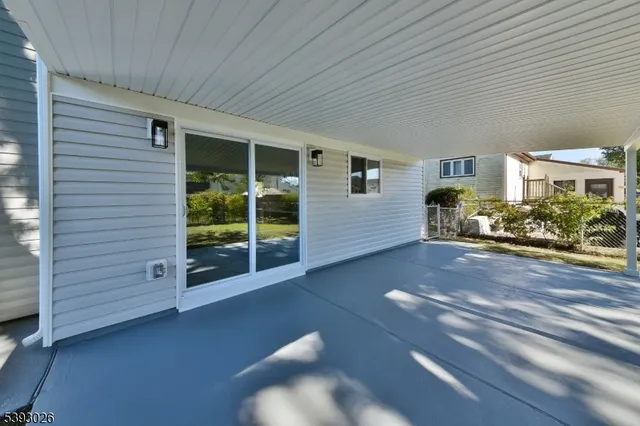 a view of a porch with furniture and a yard