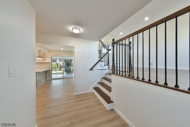 a view of entryway and hall with wooden floor