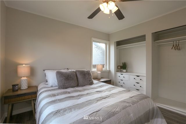 a bedroom with a large bed and a chandelier