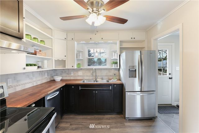 a kitchen with stainless steel appliances a sink and a refrigerator