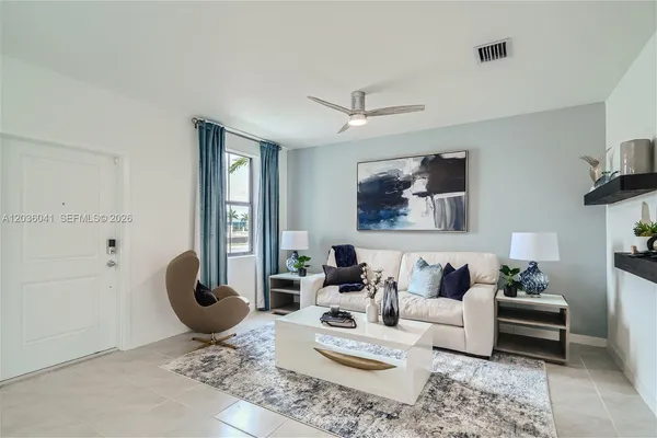 a living room with furniture a rug and wall painting