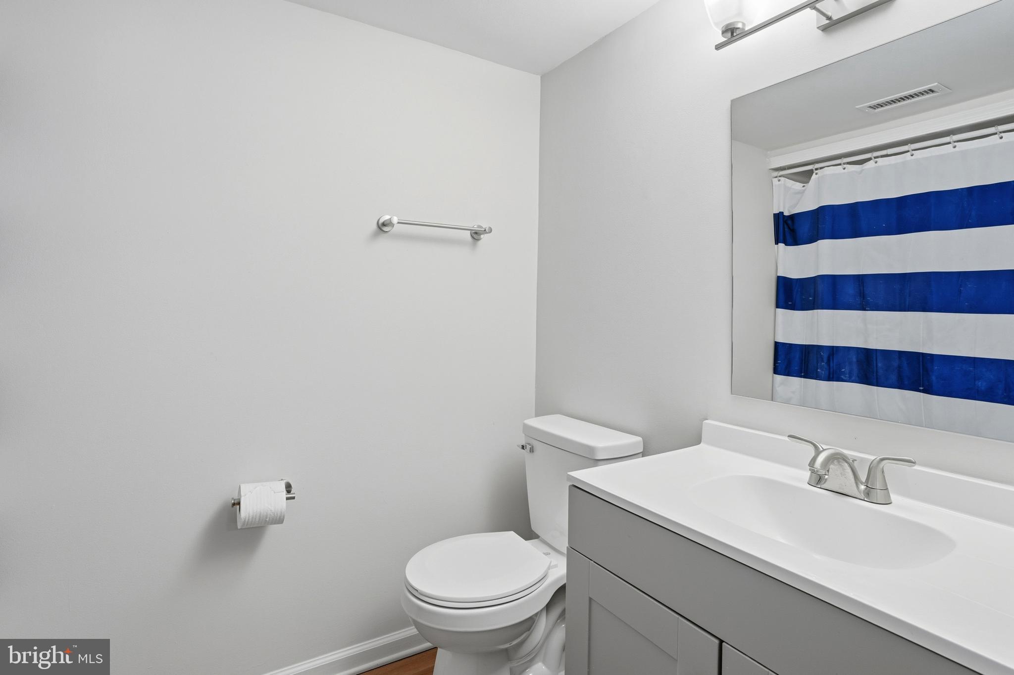 13357 Pelican Road Woodbridge, VA 22193 - Photo 27 of 48 a bathroom with a sink a toilet and a mirror