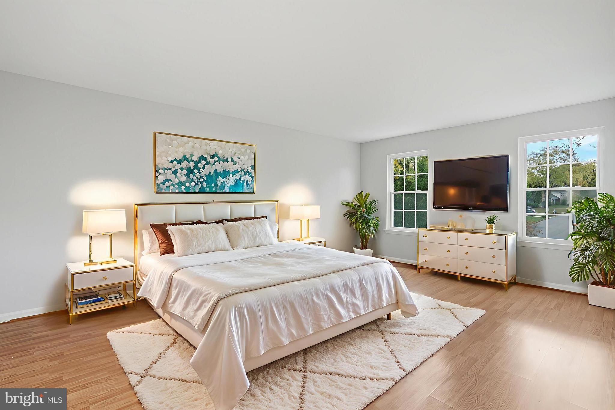 13357 Pelican Road Woodbridge, VA 22193 - Photo 29 of 48 a bedroom with a large bed a flat screen tv and a couch