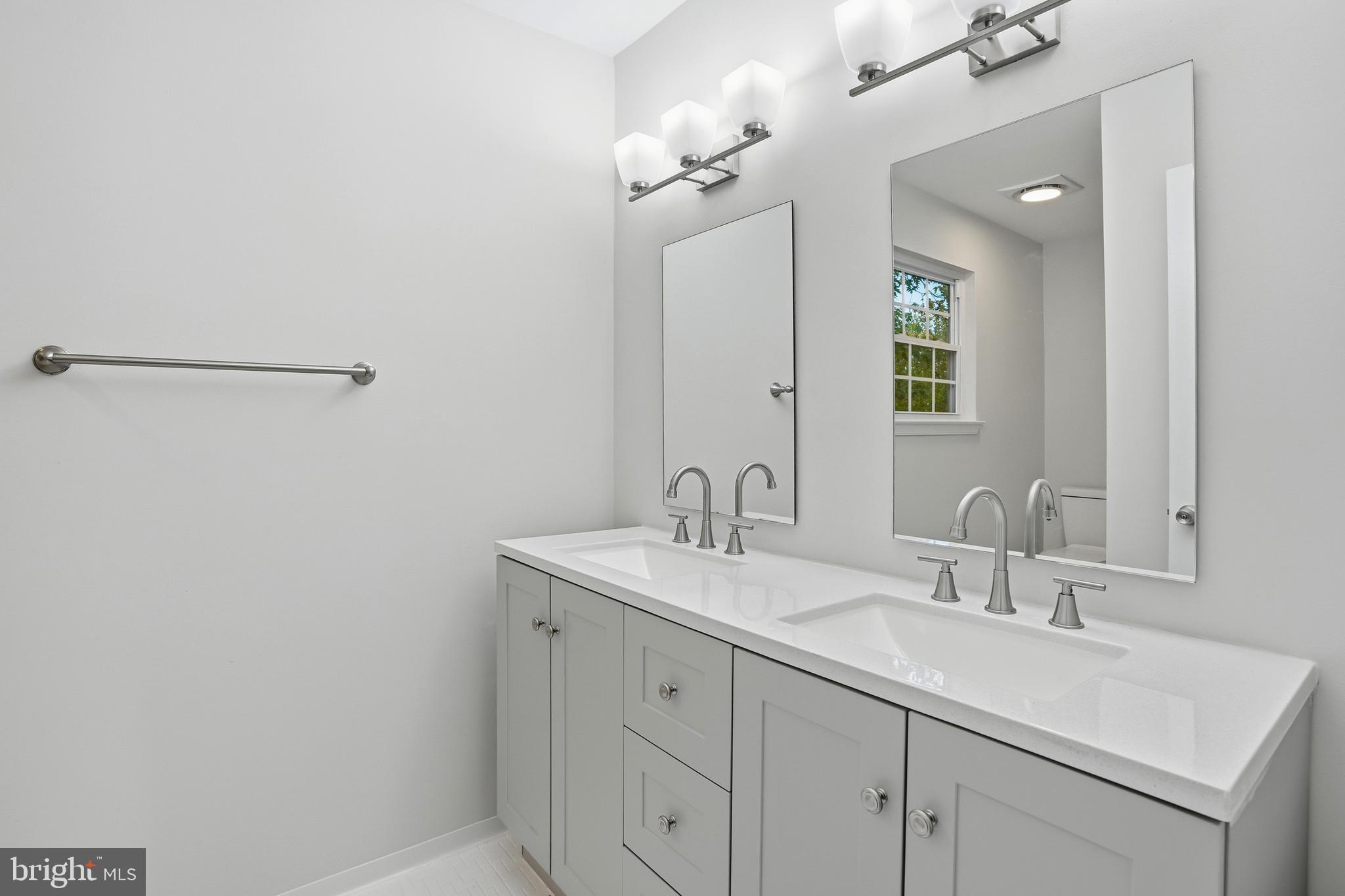 13357 Pelican Road Woodbridge, VA 22193 - Photo 32 of 48 a bathroom with a sink and a mirror