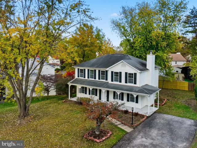 an aerial view of a houses with a lake