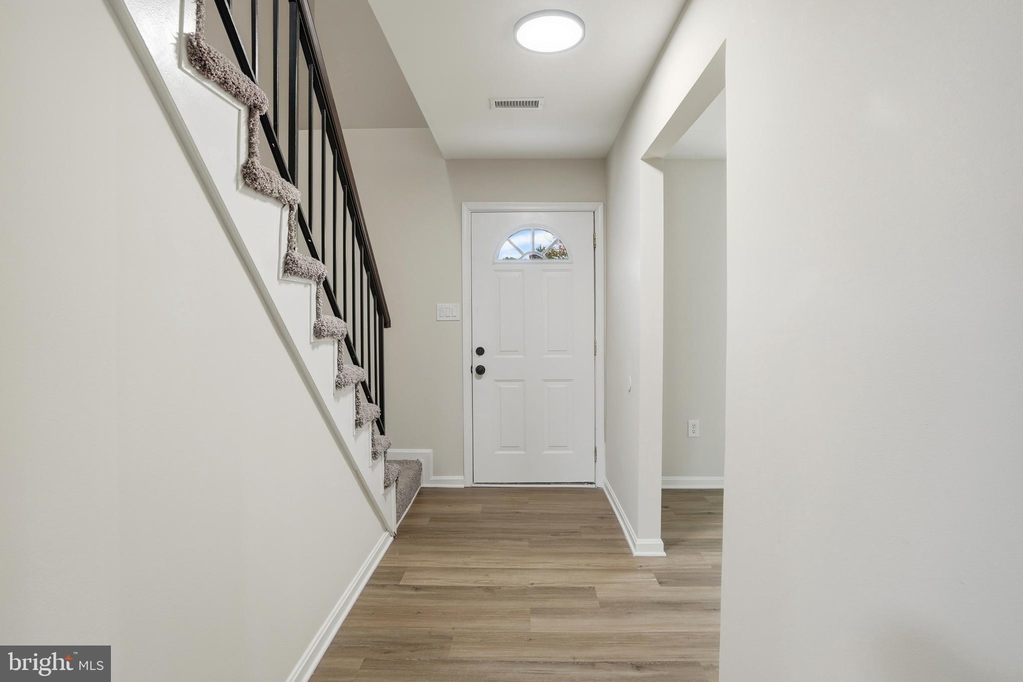 13357 Pelican Road Woodbridge, VA 22193 - Photo 8 of 48 a view of a hallway with wooden floor and staircase