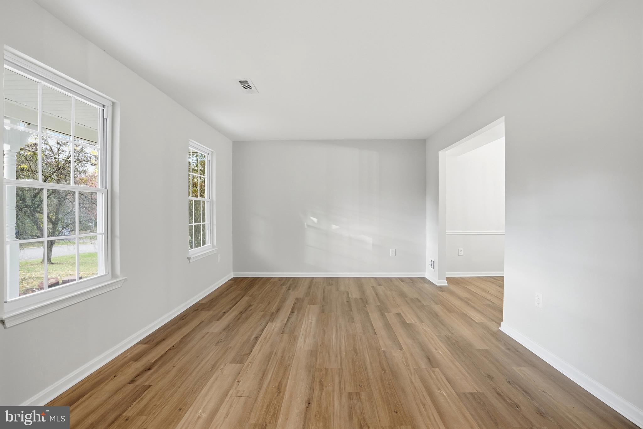 13357 Pelican Road Woodbridge, VA 22193 - Photo 10 of 48 a view of an empty room with wooden floor and a window