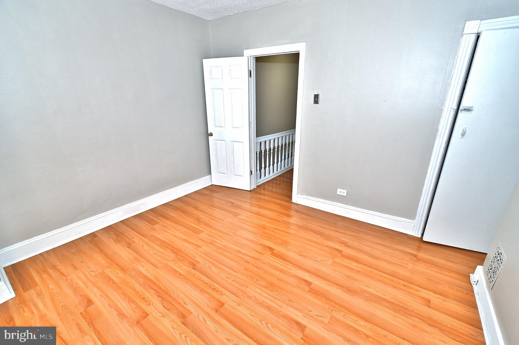 3031 North Lee Street Philadelphia, PA 19134 - Photo 6 of 12 an empty room with wooden floor and entrance
