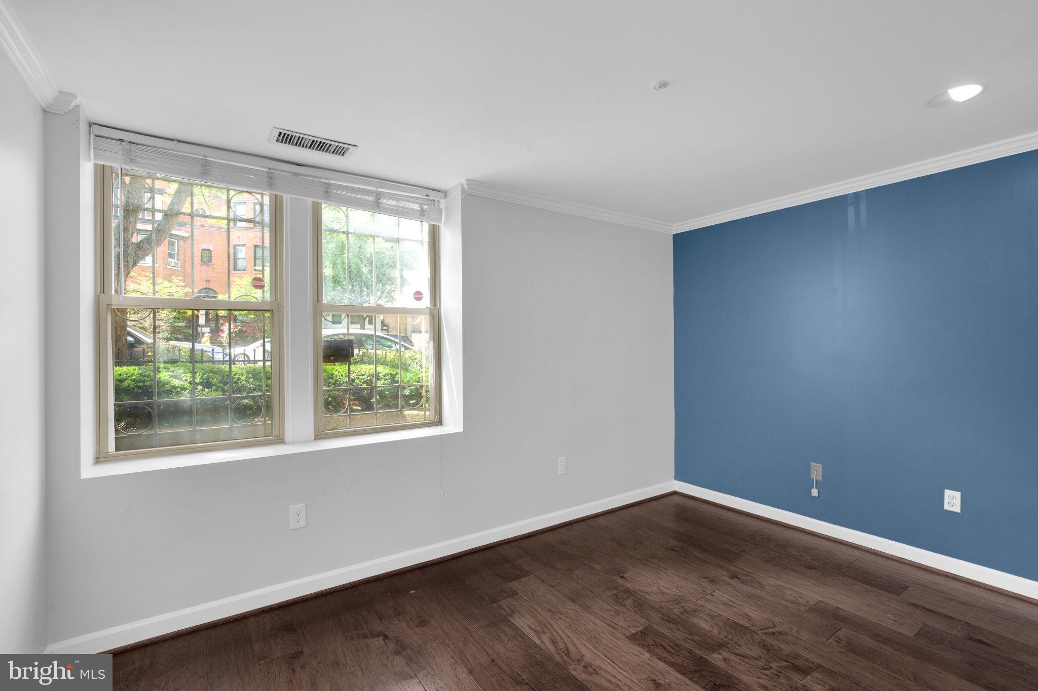 1801 Calvert Street Northwest, Unit G9 Washington, DC 20009 - Photo 12 of 19 a view of an empty room with wooden floor and a window