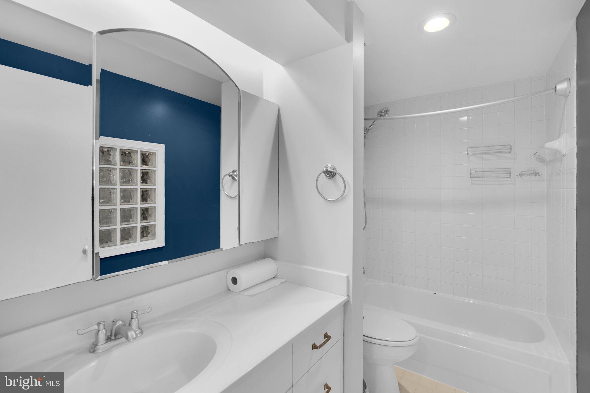 1801 Calvert Street Northwest, Unit G9 Washington, DC 20009 - Photo 15 of 19 a bathroom with a granite countertop sink a toilet and shower