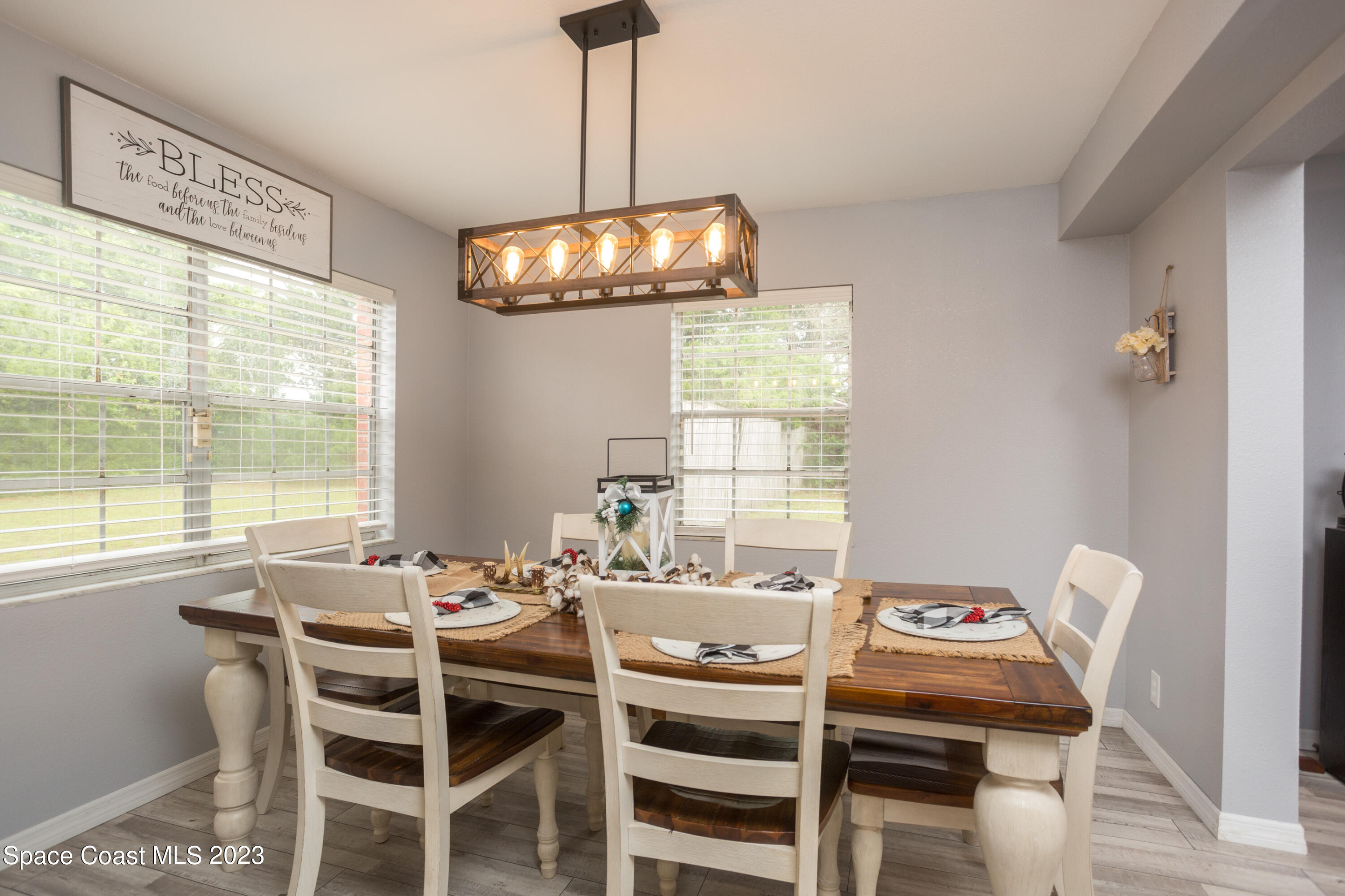 3620 Lionel Road Mims, FL 32754 - Photo 8 of 29 a view of a dining room with furniture a chandelier and wooden floor
